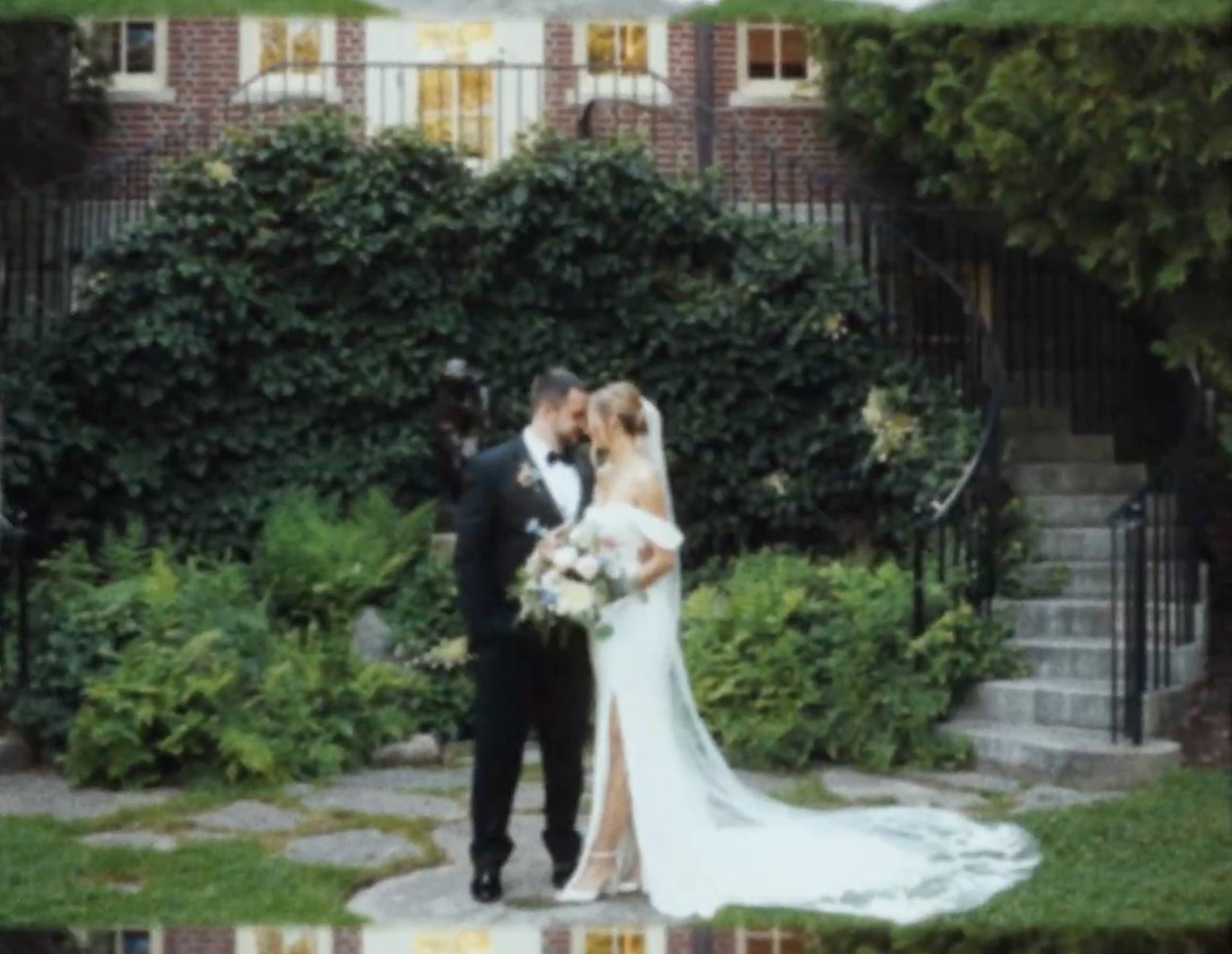 A bride and groom touching foreheads in an ivy-covered garden, from a Super8 film